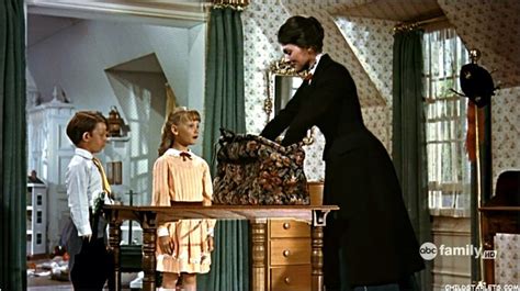 a man in a tuxedo standing next to two little boys and an older woman