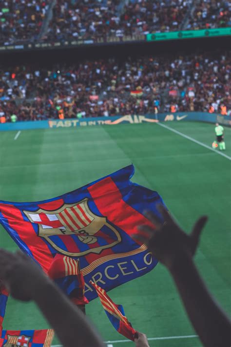 Soccer Match and a Barcelona Flag · Free Stock Photo