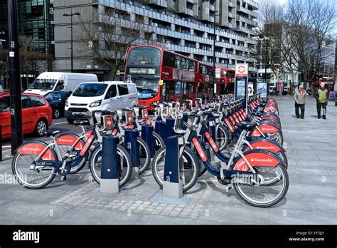 Santander Cycles or Boris Bikes, bicycle hire scheme docking station with bus, corner of ...