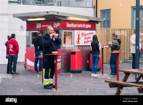 REYKJAVIK, ICELAND - AUGUST 29, 2019: People eating hot dog at ...