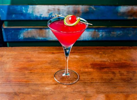 Premium Photo | Cosmopolitan cocktail served in glass topping with lime ...