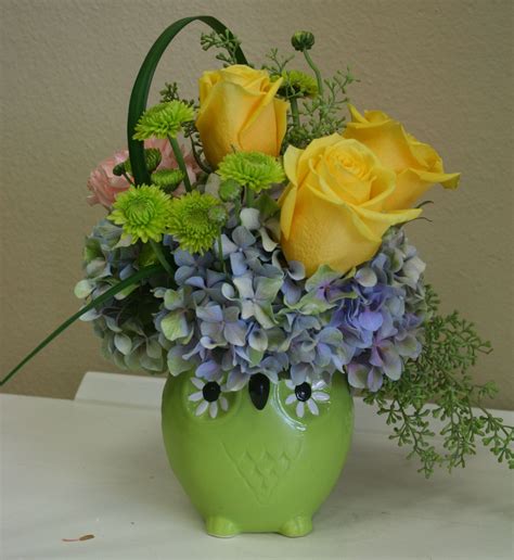 A mixed flower arrangement including roses and hydrangea in a ceramic owl. Arranged by… | Spring ...