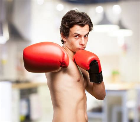 Concentrated boy training with boxing gloves Photo | Free Download