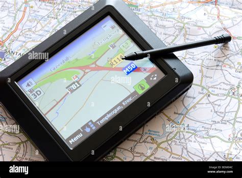 GPS global positioning system device arranged with map Stock Photo - Alamy