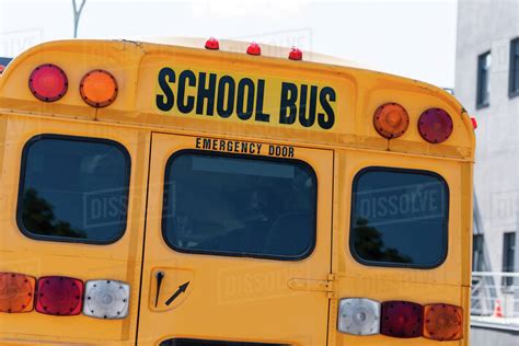 rear view of traditional school bus with inscription over back door - Stock Photo - Dissolve