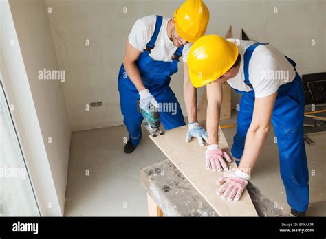 group of builders with tools indoors Stock Photo - Alamy