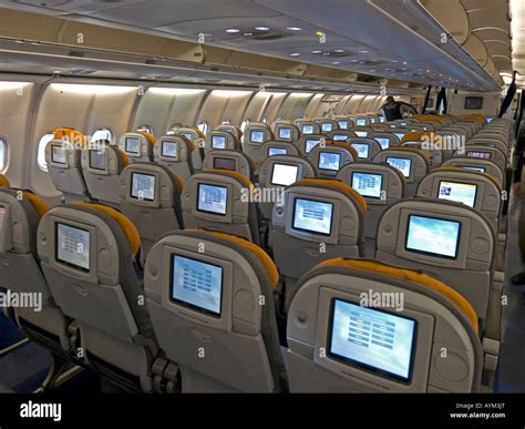 interior view in an aeroplane cabin seats economy class inseat video display Lufthansa Stock ...