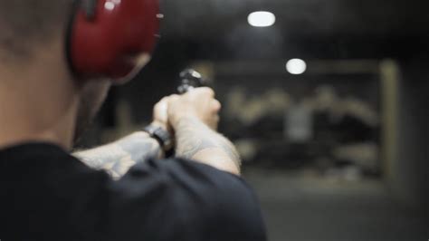 A Man Sitting While Holding a Gun · Free Stock Video
