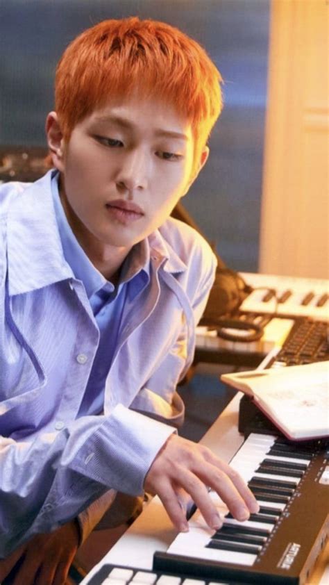 a young man sitting in front of a keyboard
