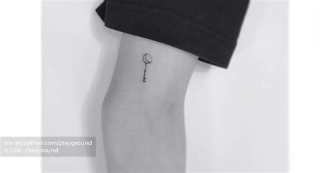 Tiny minimalistic Moon Stick tattoo located on the