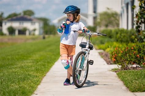 Premium Photo | Kid riding bike in a helmet child with a childs bike ...