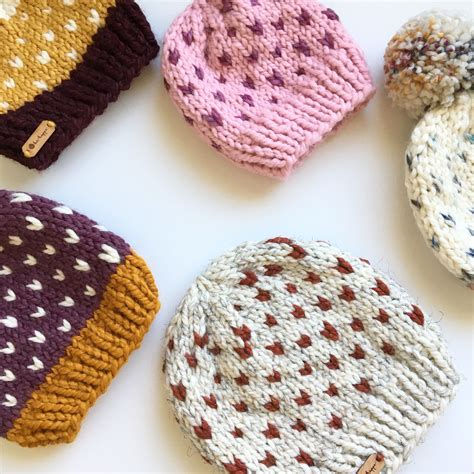 four knitted hats laid out on top of each other