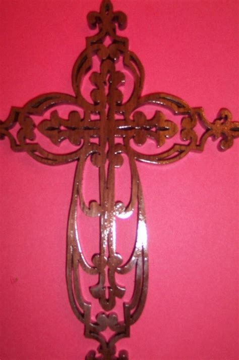 This is a beautifully hand scrolled wooden cross with a fleur de lis design. This comes ...