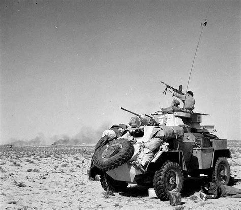 1943, North Africa. The crew of a Humber Mark II armoured car opening fire against enemy ...