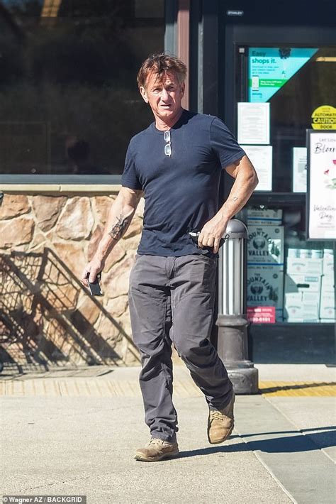 Sean Penn, 61, shows off his muscles and tattoos in a form-fitting navy ...