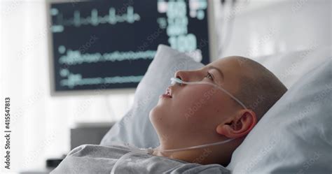 Sick child with cancer lying in hospital bed with nasal cannula Stock Photo | Adobe Stock