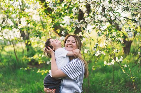 Happy mother's day. Mother with little baby son in spring garden during ...