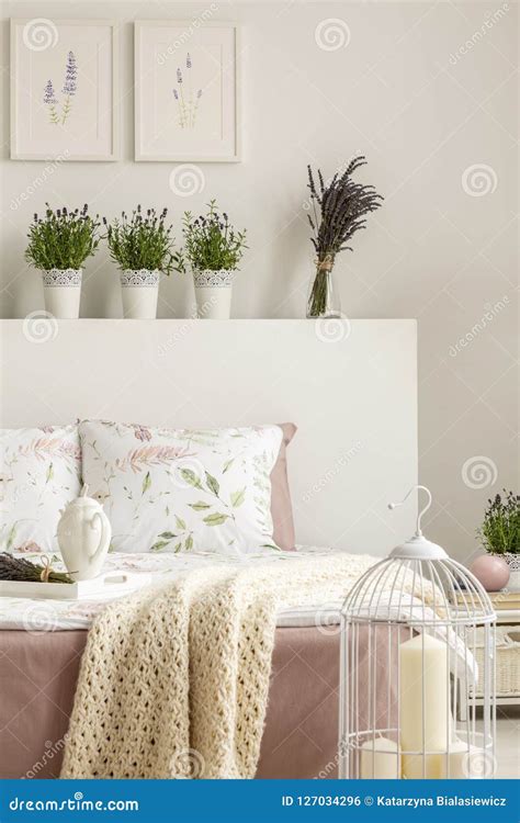 Lavender Flowers on Bedhead of Bed with Blanket in Bright Bedroom ...