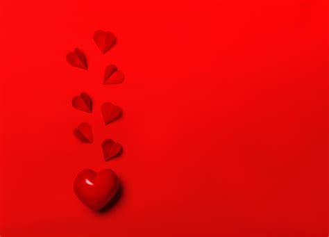 Premium Photo | The red heart shapes on abstract light glitter background