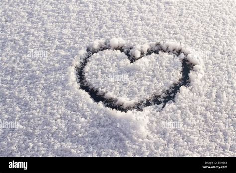 Heart shape on snow Stock Photo - Alamy