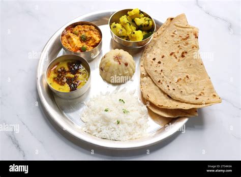 Indian vegetarian Thali or platter includes Aloo ki sabji, dal rice ...