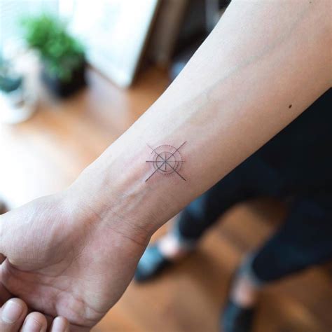 Hand poked small compass tattoo - Tattoogrid.net