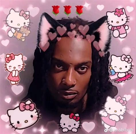 a man with hello kitty ears on his head in front of many hearts and roses