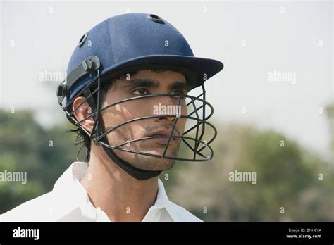 Cricket batsman wearing a helmet Stock Photo - Alamy