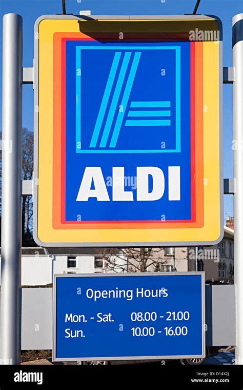 Aldi supermarket sign with opening hours, Abergavenny, Wales, UK Stock Photo - Alamy