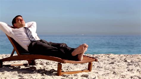 Unstressed Businessman Using Laptop On The Beach Laying On A Deck Chair Stock Footage Video ...