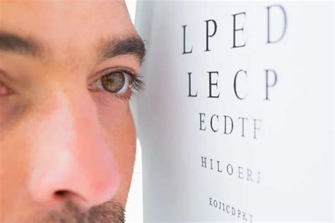 Focused man on eye test letters - Stock Image - Everypixel