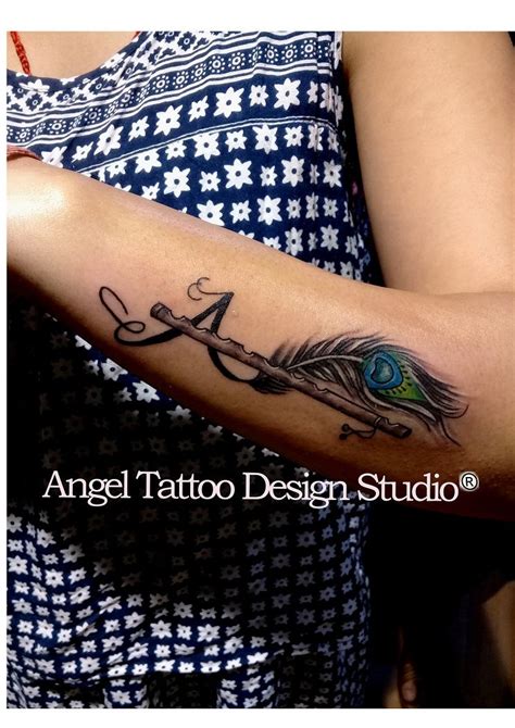 Peacock feather with flute and letter A made on wrist. At Angel Tattoo ...