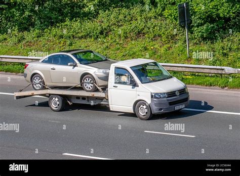 2009 white VW Volkswagen flatbed truck; car carrier Vehicular traffic ...