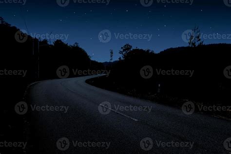 Starry night sky and winding road 12232513 Stock Photo at Vecteezy