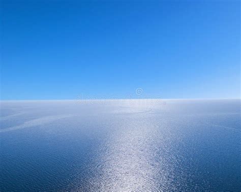 Aerial View of a Blue Sea Water Background and Sun Reflections. Aerial ...