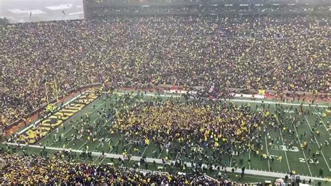 Michigan fans storm field after win over Ohio State - YouTube