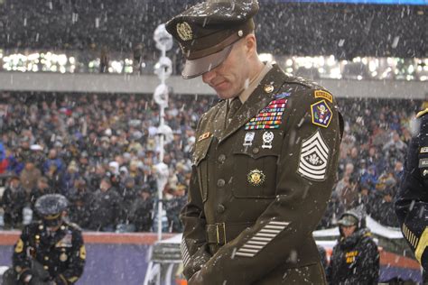 Sergeant Major of the Army Dan Dailey bows in prayer prior to kickoff ...