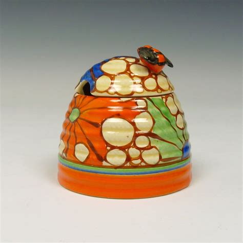 A pottery honey pot made by Clarice Cliff from England. The name of the decoration is 'Broth ...