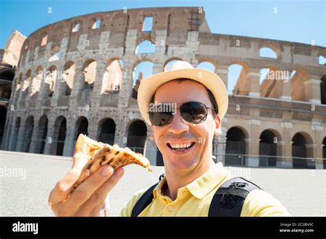 Man Eating Italian Pizza Near Colosseum, Rome Stock Photo - Alamy