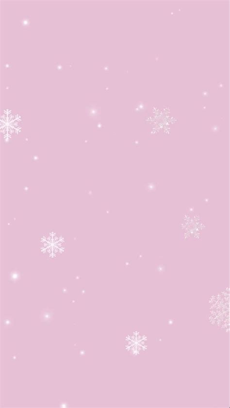 a pink background with white snowflakes and sparkles on it's edges