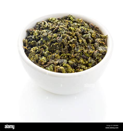 Tieguanyin tea leaves in a ceramic bowl on white background Stock Photo ...