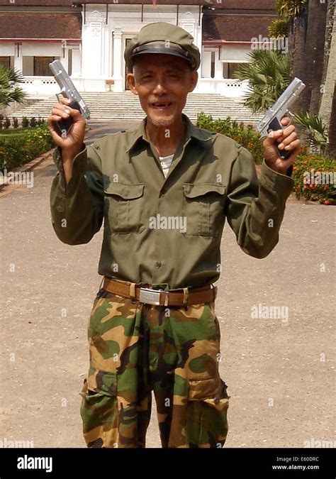 A security guard shoes off his guns in the city of Luang Probang, Laos ...