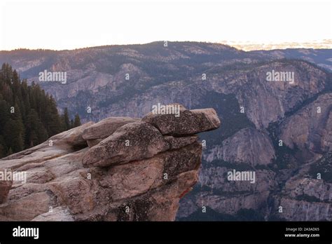 Overhanging rock with the view of famous Half Dome at Glacier Point ...