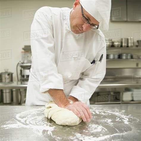 Baker kneading bread dough - Stock Photo - Dissolve