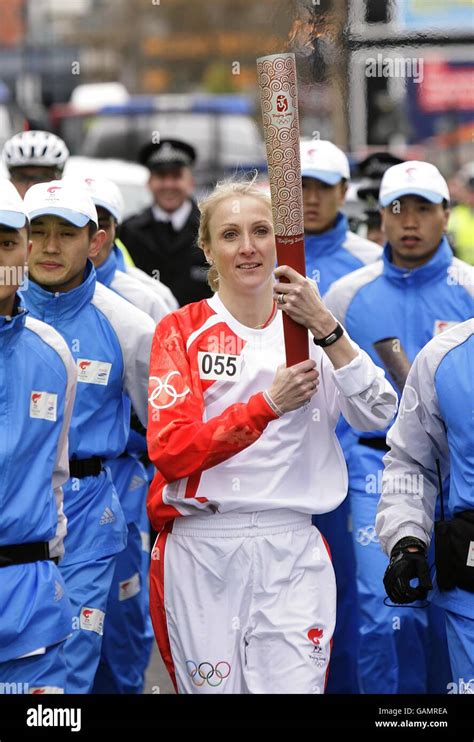 Beijing Olympics Torch Relay - London. Paula Radcliffe carries the torch towards Tower Bridge ...