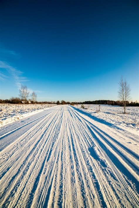 Snow Covered Winter Road with Tire Tracks Stock Photo - Image of frosty ...