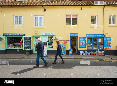 Salcombe shops, view in summer of a couple eating ice creams as they ...