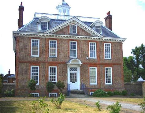 an old brick house with white trim and windows