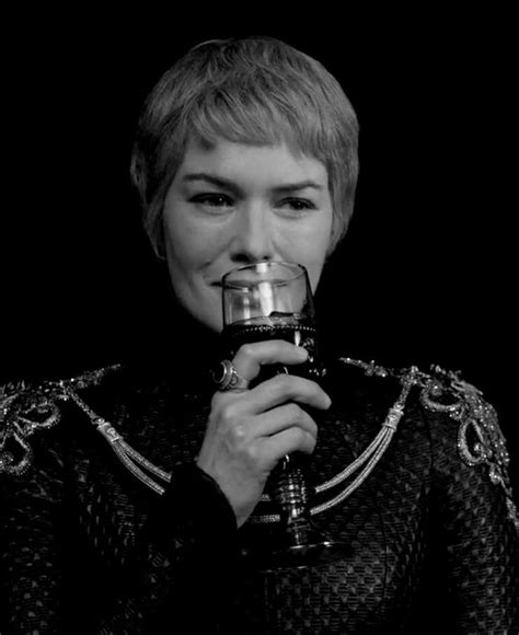 a woman holding a wine glass in front of her face