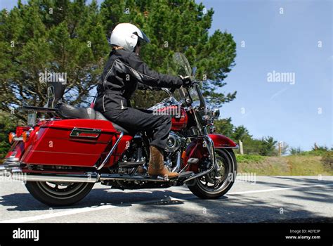 "A "Middle aged" woman riding a "Harley Davidson" "Road King" "V twin" motorcycle, California ...